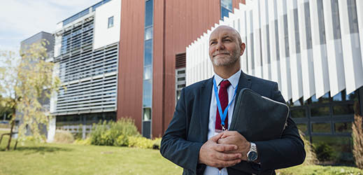 adult standing outside in front of building